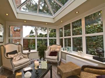 HOYLAKE WIRRAL : Design and build orangery. Quantel ODG white Pvcu roof , glazed with Pilkington Clear Activ double glazed units. Dec 2800 white PvcU Windows with feature ornamental head section 